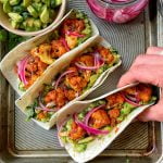 An image of Buffalo cauliflower wing tacos with quick pickled onion