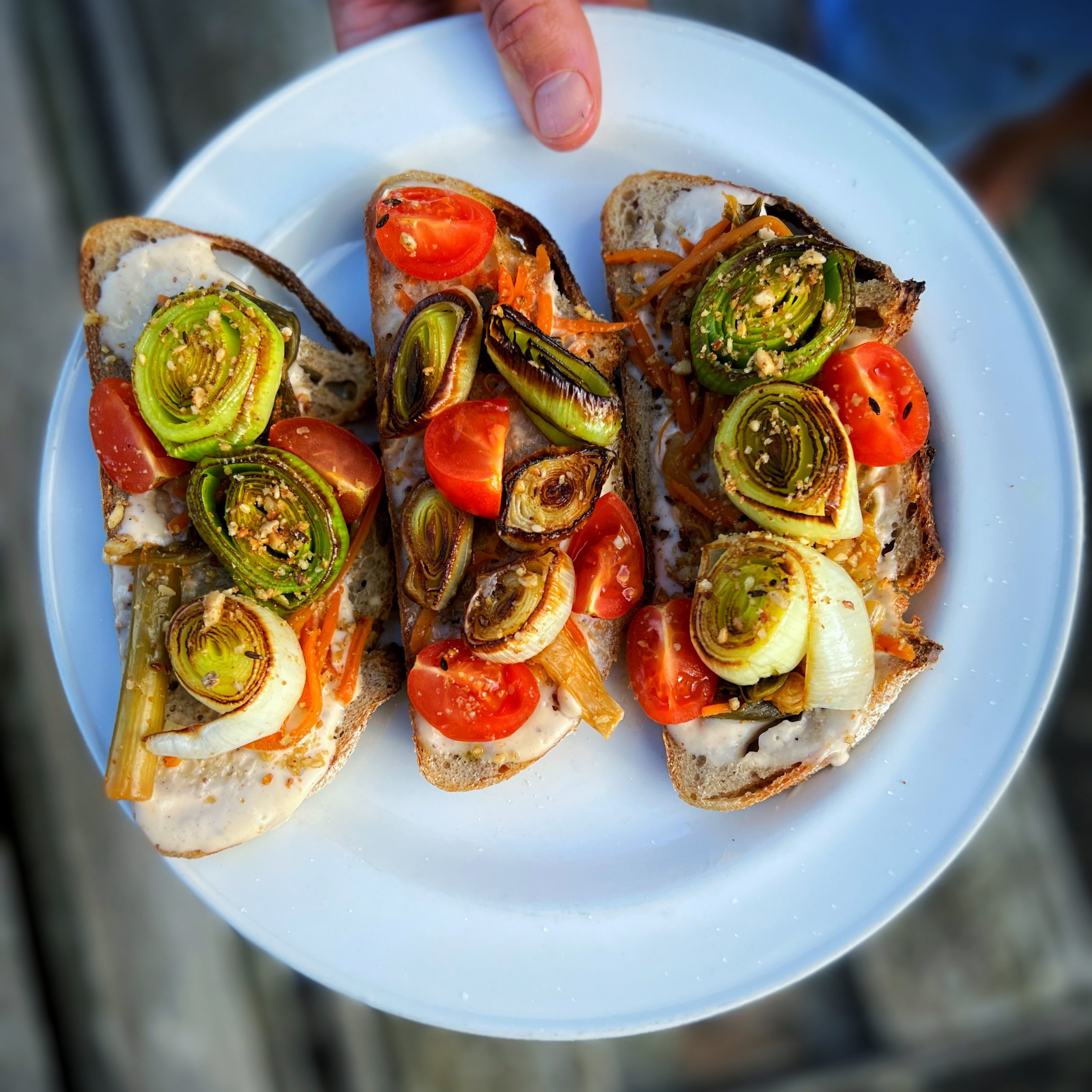 An image of Charred leek open topped sandwich with Kimchi mayo