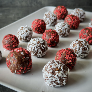 photo of raspberry & coconut covered Mood Boosting Nettle Seed Serotonin Energy Balls