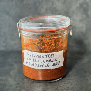 a photo of fermented garlic and chilli paste in a jar