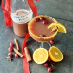 a photo of a glass and a bottle of Fermented Festive Fruit Punch