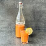 a photo of a glass and a bottle of Natural Juice Soda