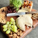 a photo of a cheese board with Fermented Cashew Cheese