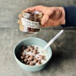 a photo of a bowl and a jar of Quinoa Crunch Breakfast Cereal