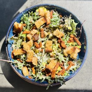 a photo of a bowl of Farm Kale Caesar Salad