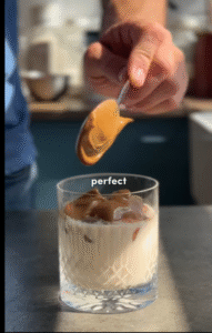 An Image of a Glass of Whipped Coffee with Maple Syrup (Dalgona-style)