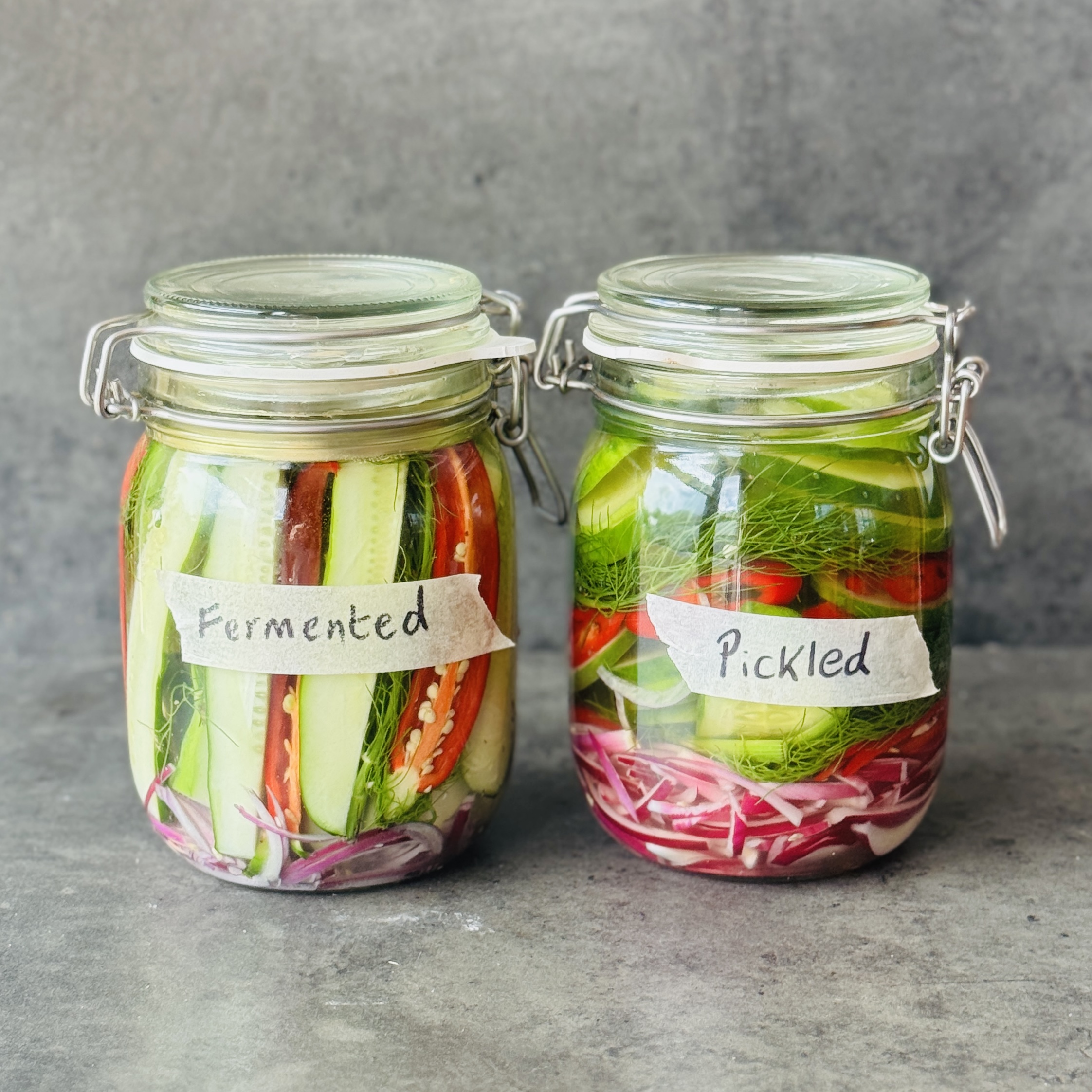 a photo of 2 jars of Cucumbers 2 Ways : Pickled & Fermented