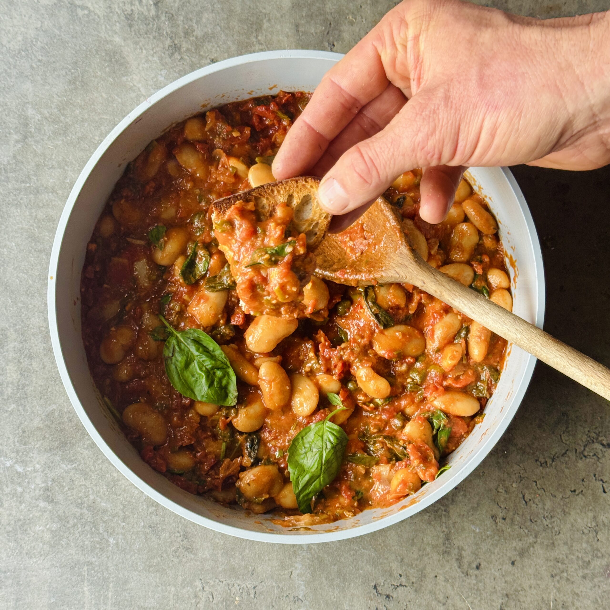 a photo of Tuscan One-Pan Bean Bake with Sun-Dried Tomatoes & Basil