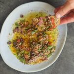 a photo of Loaded Olive Oil Dip with Herbs, Pesto, Tapenade & Capers